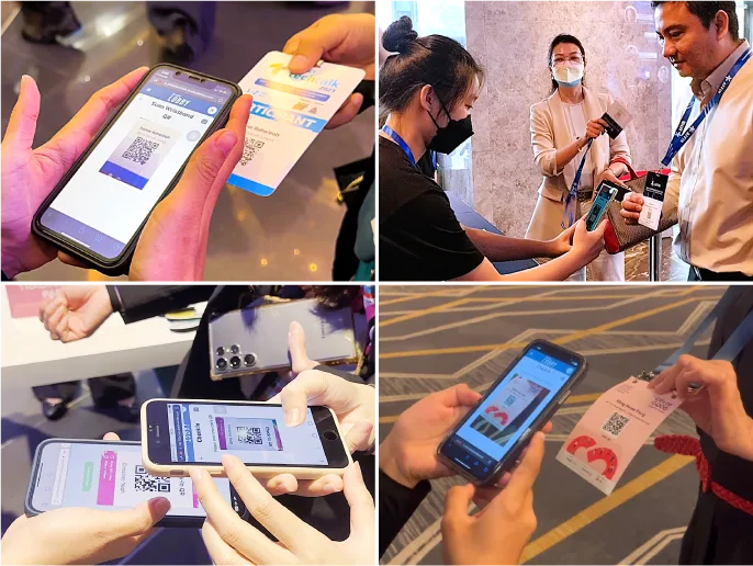 Crew assisting attendee with QR code scan for event check-in and attendance tracking